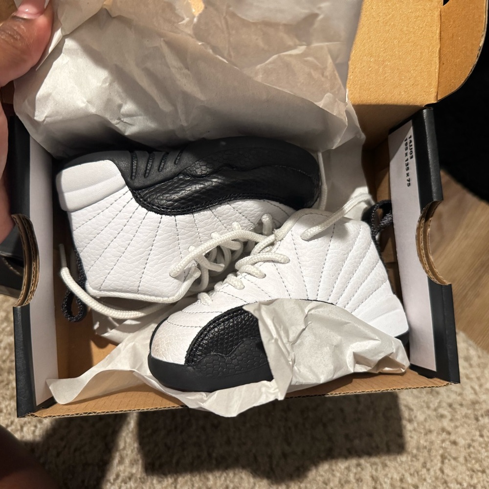 Jordan 12 toddler Black and white. Blue and white sneakers.
